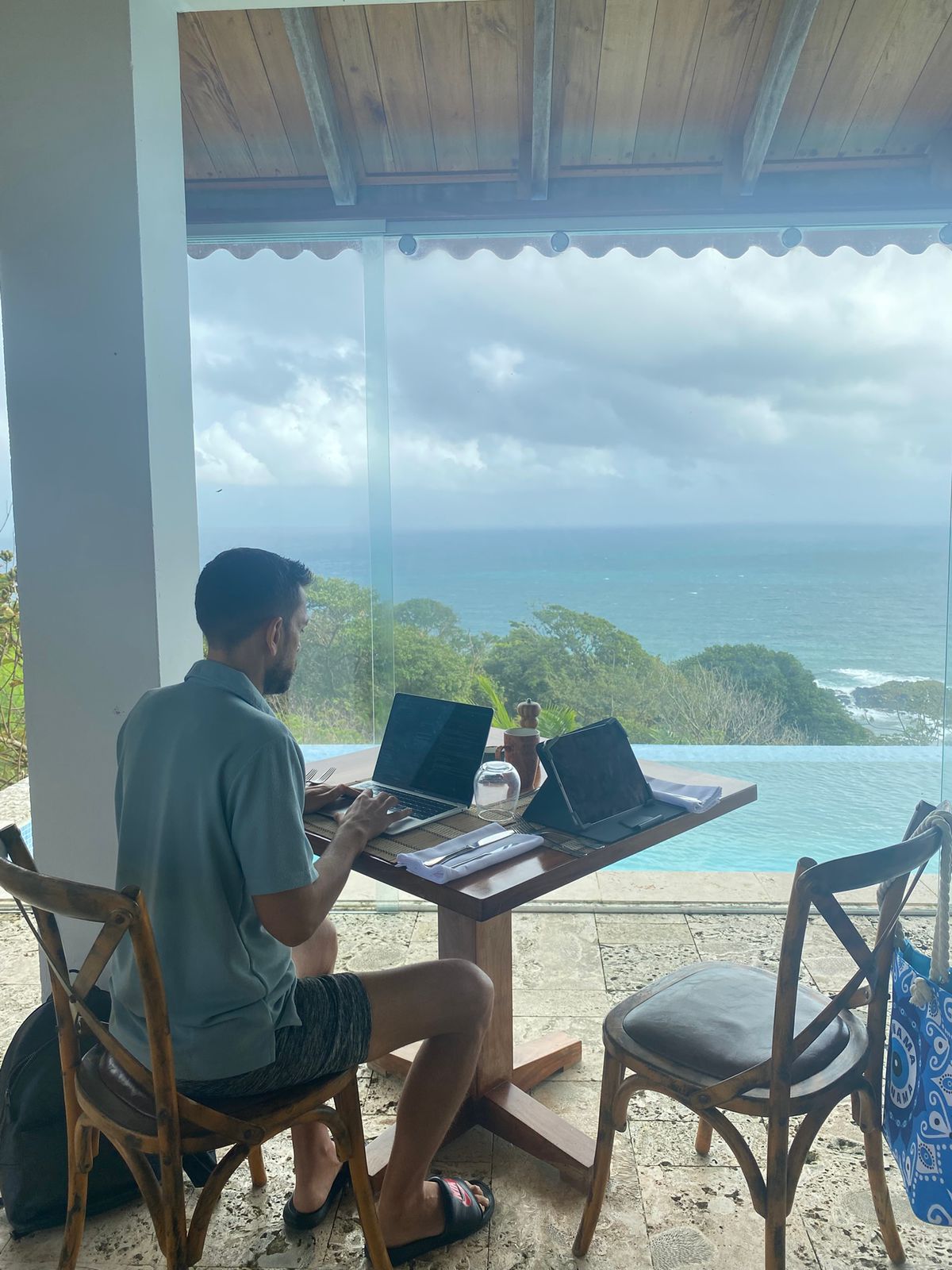 Sean working on a laptop with an ocean view